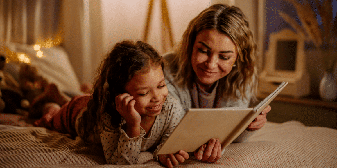 child and her mother reading a book
